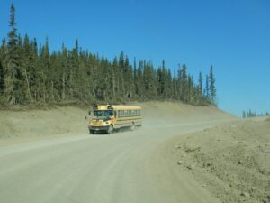 Standard bus driving down a mining road